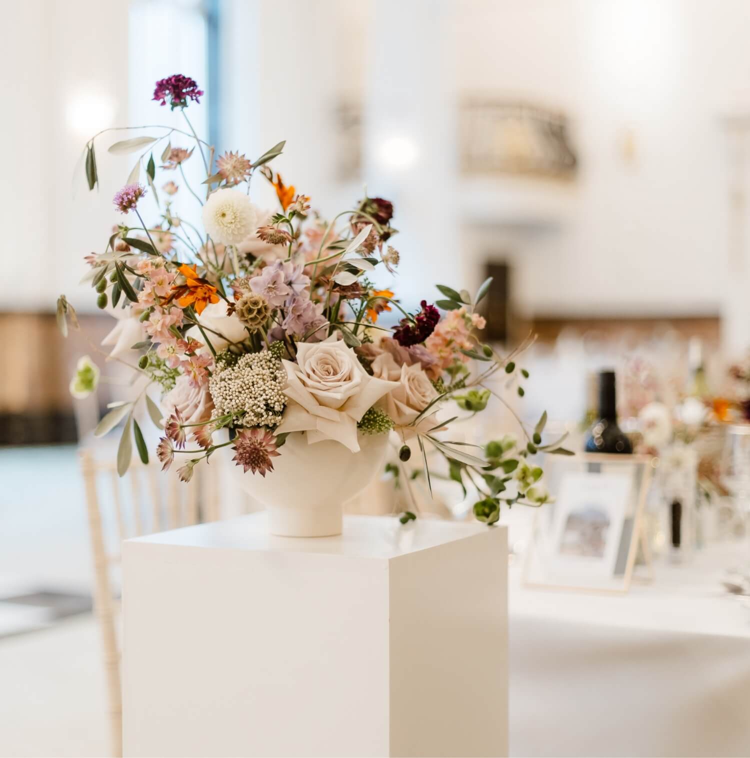 Beautiful bespoke wedding flowers in a white vase